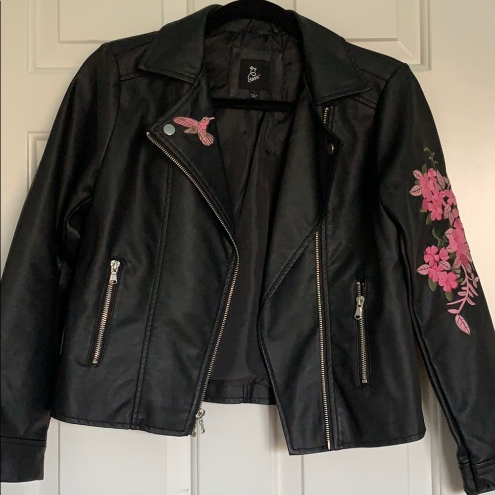 Black leather jacket with pink nature patches.
